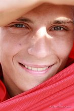 Red wife-beater twink shows off his six-pack outdoors