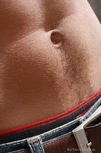 Red wife-beater twink shows off his six-pack outdoors