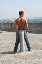 Red wife-beater twink shows off his six-pack outdoors