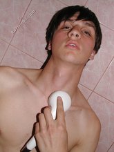 Dark-haired guy shows his ass in the showers