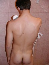 Dark-haired guy shows his ass in the showers