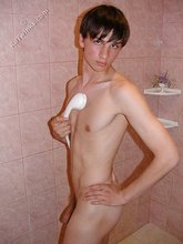 Dark-haired guy shows his ass in the showers