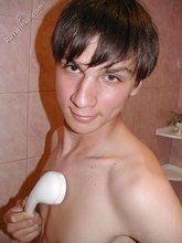 Dark-haired guy shows his ass in the showers