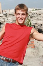 Jacked-up young boy showing his abs on the roof