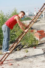 Jacked-up young boy showing his abs on the roof