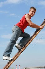 Jacked-up young boy showing his abs on the roof