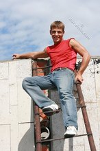 Jacked-up young boy showing his abs on the roof