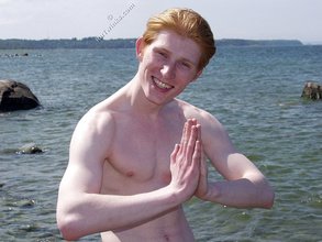 Redheaded twink posing in his sexy shades on a beach