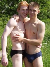 Redheaded twink posing in his sexy shades on a beach