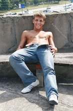 Cheerful and youthful twink takes off his baggy jeans