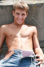 Cheerful and youthful twink takes off his baggy jeans