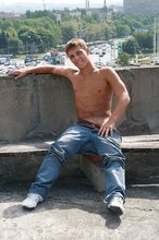 Cheerful and youthful twink takes off his baggy jeans