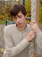 Dark-haired twink posing outdoors (with rope)