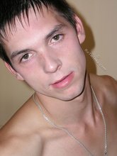 Brunette twink stroking his meaty junk on a couch