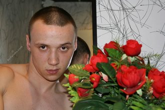 Tatted-up twink posing seductively with roses