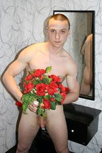 Tatted-up twink posing seductively with roses