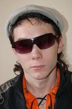 Shades-wearing twink posing seductively on camera