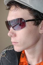 Shades-wearing twink posing seductively on camera