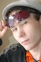 Shades-wearing twink posing seductively on camera