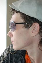 Shades-wearing twink posing seductively on camera