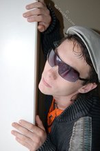 Shades-wearing twink posing seductively on camera