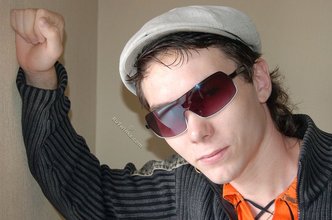 Shades-wearing twink posing seductively on camera