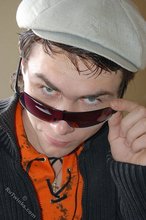 Shades-wearing twink posing seductively on camera