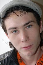 Shades-wearing twink posing seductively on camera