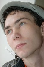 Shades-wearing twink posing seductively on camera