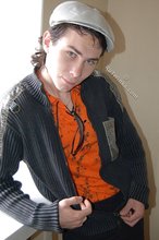 Shades-wearing twink posing seductively on camera