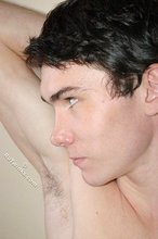Curly-haired twink flashing his sexy feet and his cock
