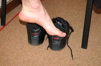Curly-haired twink flashing his sexy feet and his cock