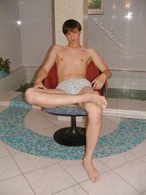 Twink with dark hair striking suggestive poses