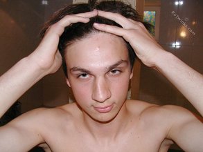 Twink with dark hair striking suggestive poses
