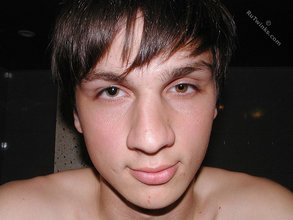 Twink with dark hair striking suggestive poses