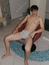 Twink with dark hair striking suggestive poses