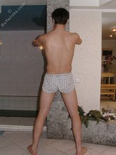 Twink with dark hair striking suggestive poses