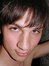 Twink with dark hair striking suggestive poses