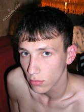 Lanky young boy sucking on a big black dildo