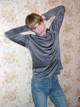 Stylish twink posing with his shirt off on the floor