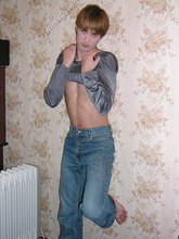 Stylish twink posing with his shirt off on the floor