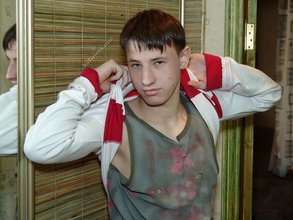Pouty dark-haired guy shows his sexy arms and abs