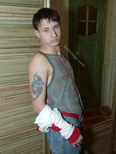 Pouty dark-haired guy shows his sexy arms and abs