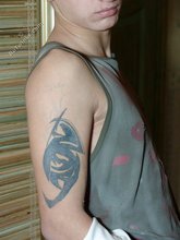 Pouty dark-haired guy shows his sexy arms and abs