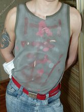 Pouty dark-haired guy shows his sexy arms and abs