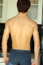 Kinky dark-haired twink posing seductively in the kitchen