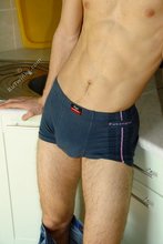 Kinky dark-haired twink posing seductively in the kitchen