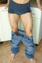 Kinky dark-haired twink posing seductively in the kitchen