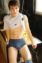 Kinky dark-haired twink posing seductively in the kitchen