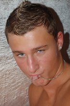 Blond-haired twink slowly taking his undies off